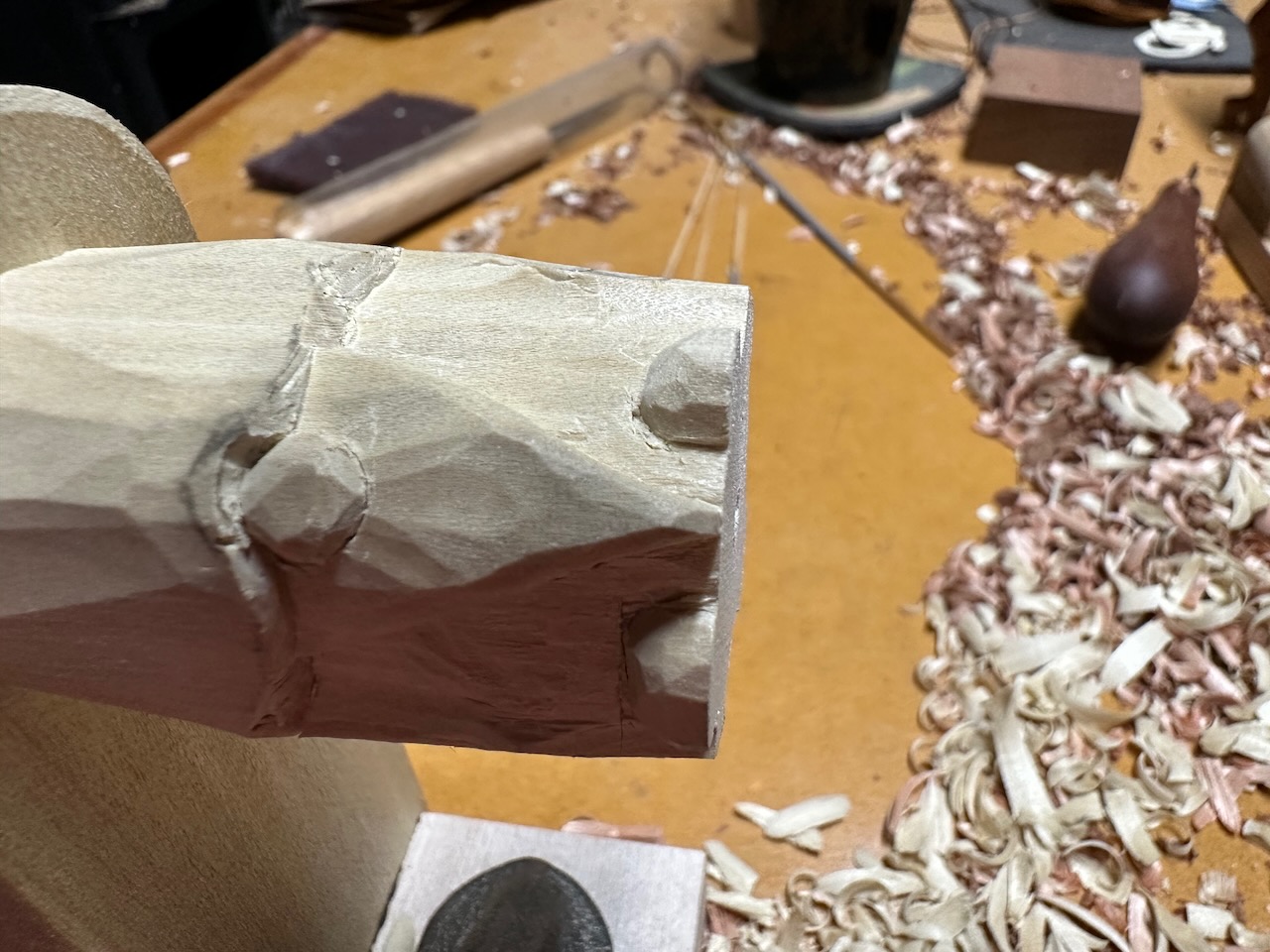 PARTLY-CARVED BEAD. WORK IS BEING DONE ON THE SIDE NOT TOUCHING THE JIG. PHOTO BY AUTHOR.