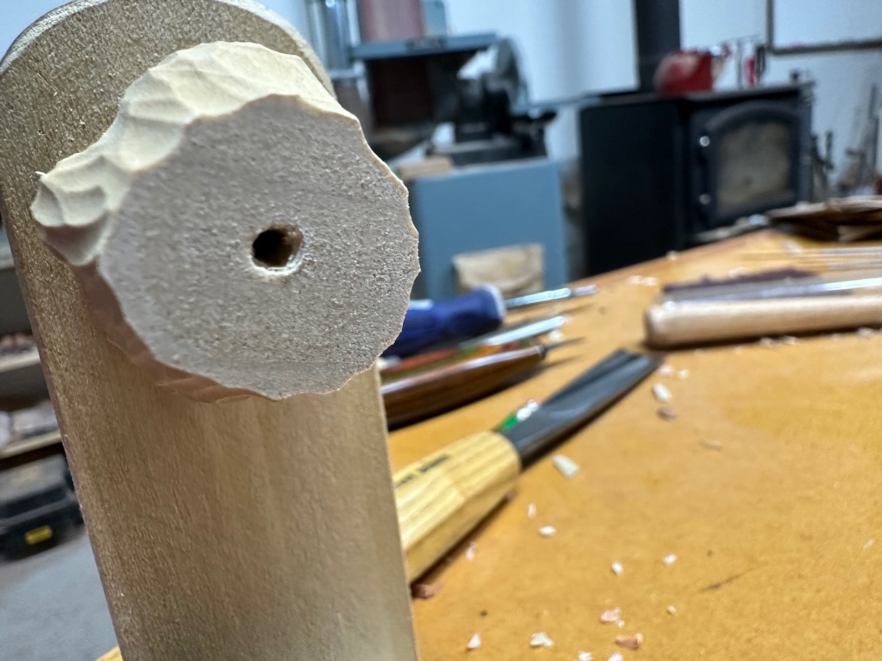 BEAD BLANK (PARTLY CARVED) SHOWING HOLE DRILLED THROUGH CENTER. PHOTO BY AUTHOR.